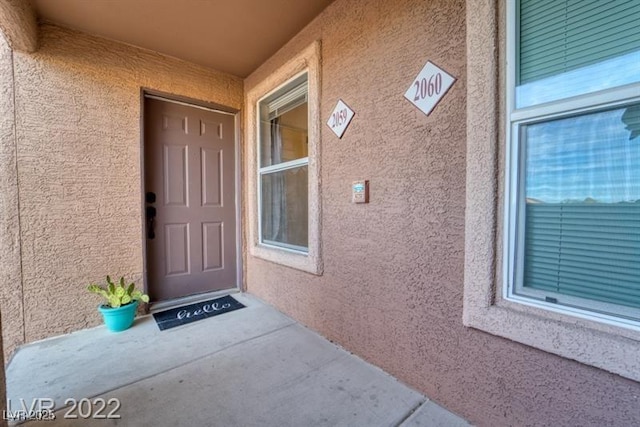 property entrance featuring stucco siding