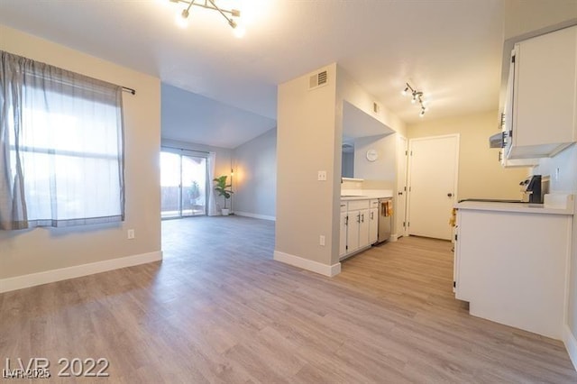 kitchen featuring dishwasher, visible vents, white cabinetry, and stove