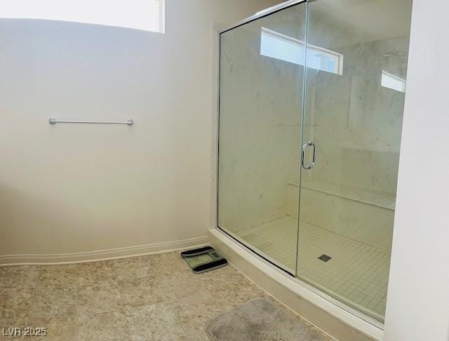 full bathroom with a stall shower, baseboards, and visible vents