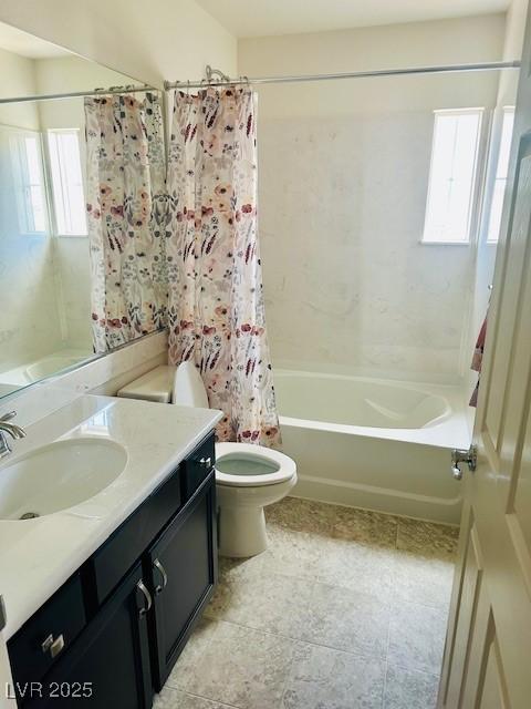 bathroom with toilet, shower / tub combo, and vanity
