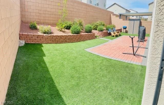 view of yard featuring a fenced backyard, a patio area, and a shed