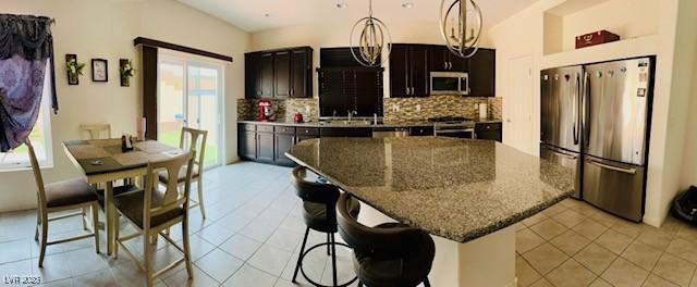 kitchen featuring appliances with stainless steel finishes, plenty of natural light, and decorative backsplash