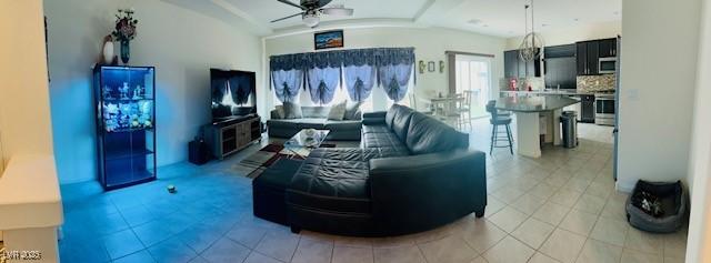 living room featuring a ceiling fan and light tile patterned floors