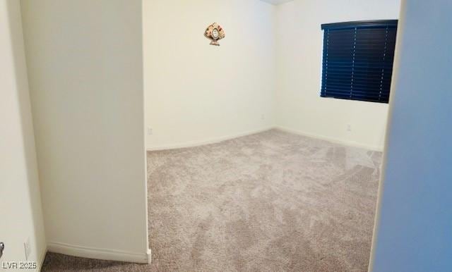 spare room with carpet and baseboards