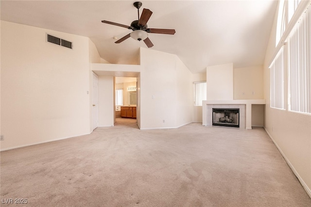 7620 Tortola Bay Ln, Las Vegas, NV 89128 - unfurnished living room featuring visible vents, ceiling fan, vaulted ceiling, and light colored carpet