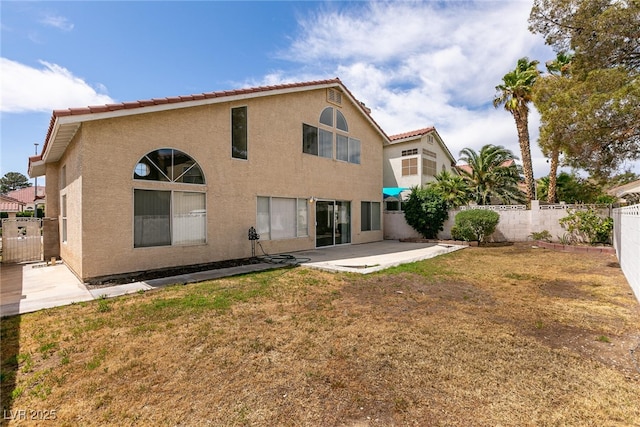 7620 Tortola Bay Ln, Las Vegas, NV 89128 - rear view of property with a patio, stucco siding, a fenced backyard, and a tiled roof