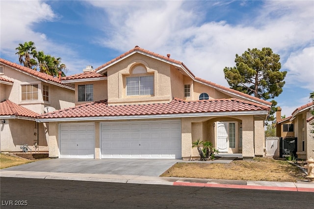 7620 Tortola Bay Ln, Las Vegas, NV 89128 - mediterranean / spanish-style home with an attached garage, a tiled roof, driveway, and stucco siding