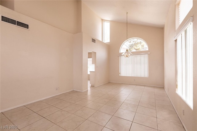 7620 Tortola Bay Ln, Las Vegas, NV 89128 - empty room with light tile patterned flooring, visible vents, and a chandelier