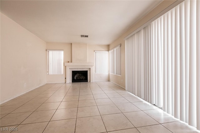 7620 Tortola Bay Ln, Las Vegas, NV 89128 - unfurnished living room with a fireplace, light tile patterned flooring, visible vents, and a healthy amount of sunlight