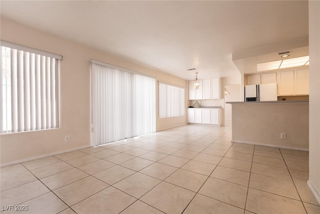 7620 Tortola Bay Ln, Las Vegas, NV 89128 - unfurnished living room featuring light tile patterned floors and baseboards