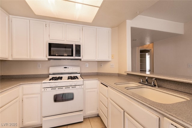 7620 Tortola Bay Ln, Las Vegas, NV 89128 - kitchen featuring white cabinets, stainless steel microwave, white range with gas stovetop, and a sink