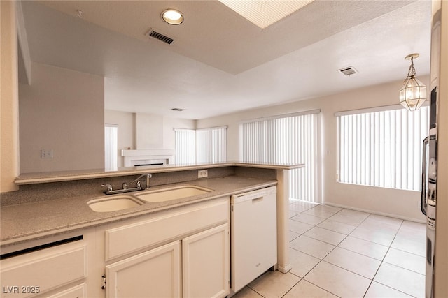7620 Tortola Bay Ln, Las Vegas, NV 89128 - kitchen featuring plenty of natural light, dishwasher, visible vents, a sink, and light tile patterned flooring
