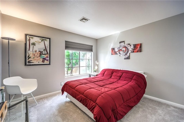 carpeted bedroom with visible vents and baseboards