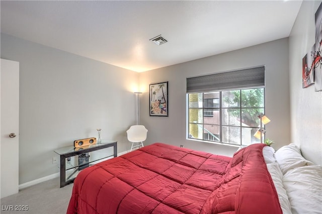 carpeted bedroom featuring baseboards and visible vents