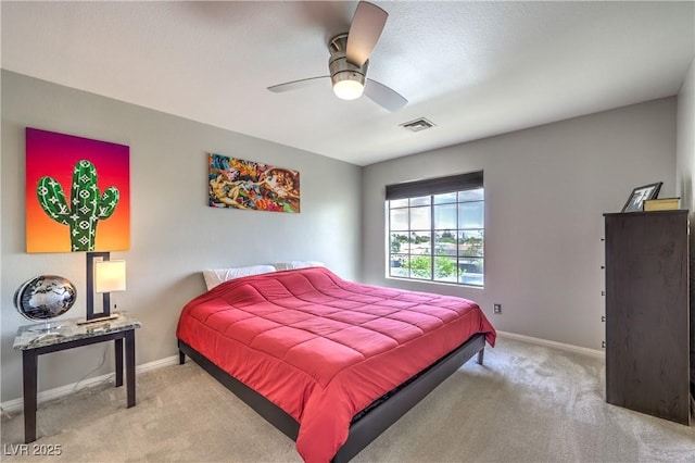 carpeted bedroom featuring visible vents, ceiling fan, and baseboards