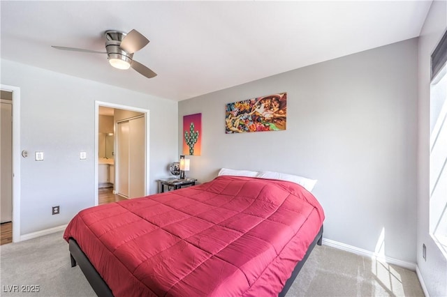 bedroom with a ceiling fan, carpet flooring, connected bathroom, and baseboards
