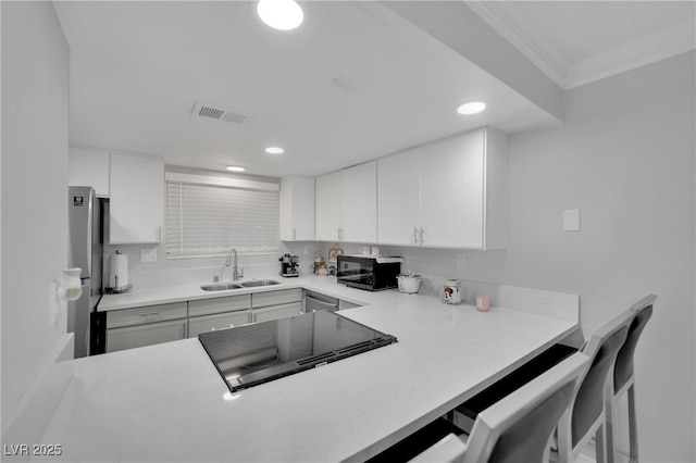 2080 Karen Ave Unit 1, Las Vegas, NV 89169 - kitchen with a sink, black appliances, recessed lighting, ornamental molding, and light countertops