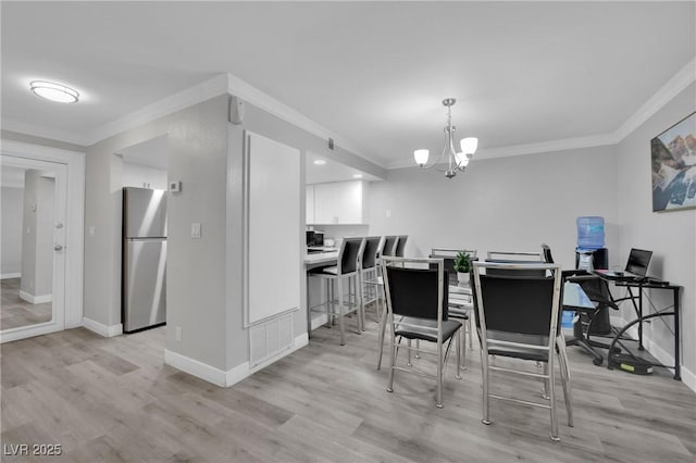 2080 Karen Ave Unit 1, Las Vegas, NV 89169 - dining room featuring baseboards, light wood-style flooring, ornamental molding, and a chandelier