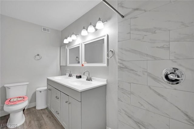 2080 Karen Ave Unit 1, Las Vegas, NV 89169 - bathroom with double vanity, toilet, wood finished floors, and a shower