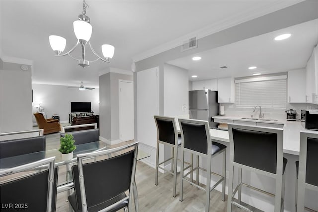 2080 Karen Ave Unit 1, Las Vegas, NV 89169 - kitchen with stainless steel appliances, a sink, a ceiling fan, light countertops, and ornamental molding