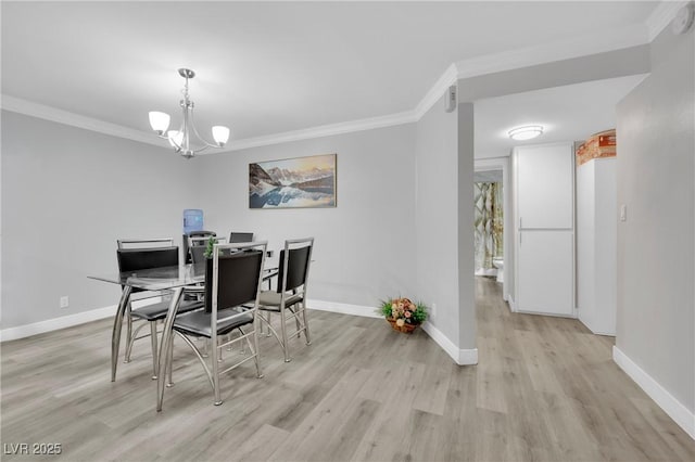 2080 Karen Ave Unit 1, Las Vegas, NV 89169 - dining space with ornamental molding, light wood-style floors, baseboards, a chandelier, and a desk