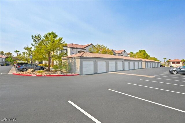 950 Seven Hills Dr Unit 116, Henderson, NV 89052 - uncovered parking lot with community garages and a residential view