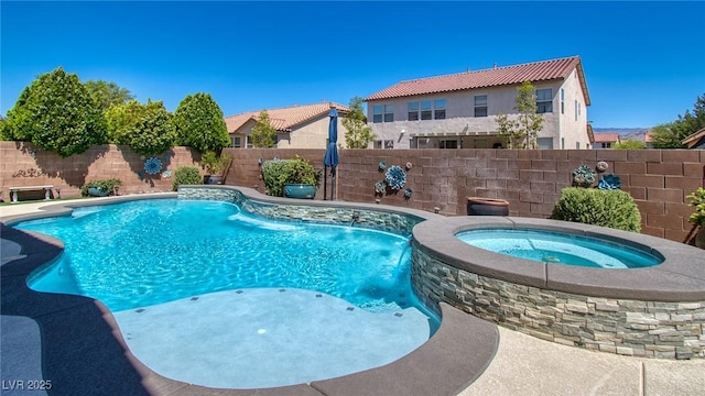 view of pool with an in ground hot tub, a fenced in pool, and a fenced backyard