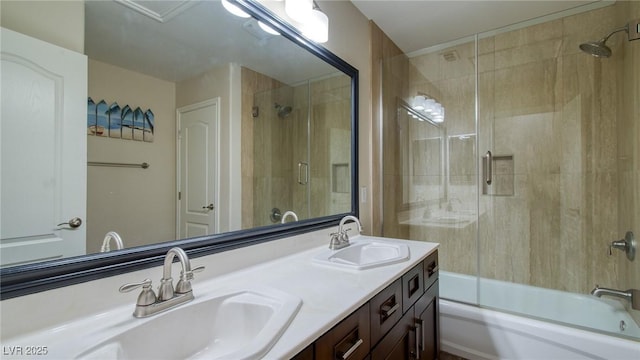 full bath with double vanity, shower / bath combination with glass door, and a sink