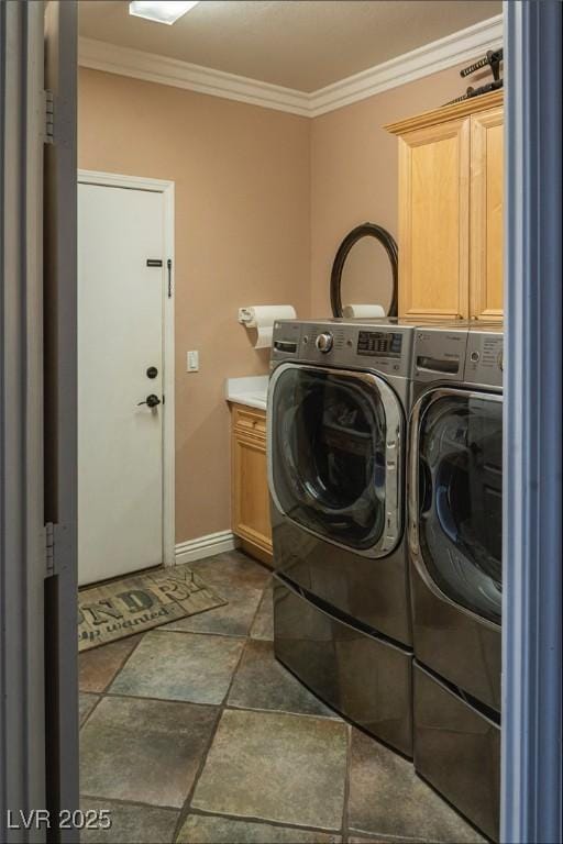 laundry room with washing machine and clothes dryer, crown molding, cabinet space, baseboards, and stone finish floor
