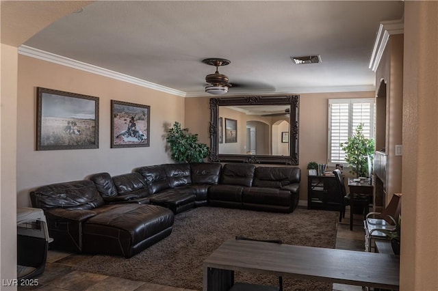 living area with a ceiling fan, crown molding, and visible vents