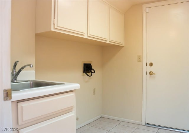 9704 Falling Star Ave, Las Vegas, NV 89117 - laundry area with cabinet space, light tile patterned floors, and baseboards