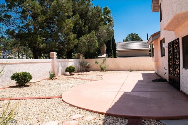 9704 Falling Star Ave, Las Vegas, NV 89117 - fenced backyard with a patio area