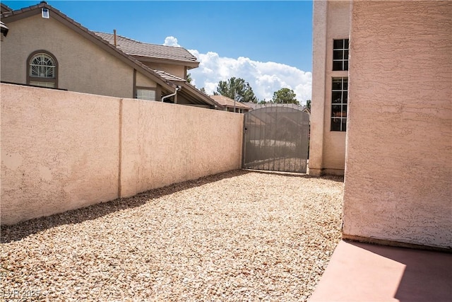 9704 Falling Star Ave, Las Vegas, NV 89117 - view of home's exterior featuring stucco siding and a gate
