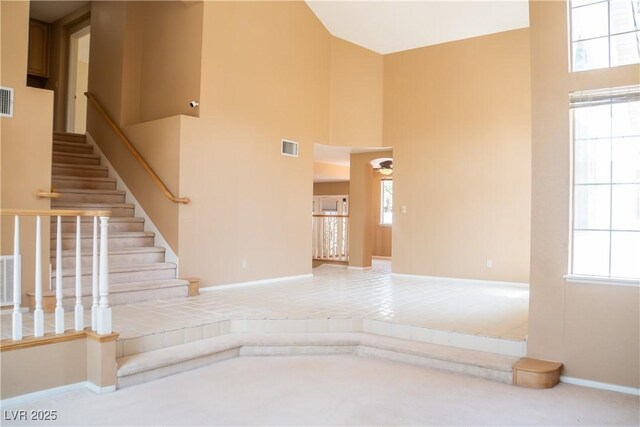 9704 Falling Star Ave, Las Vegas, NV 89117 - stairway with baseboards, a high ceiling, and carpet