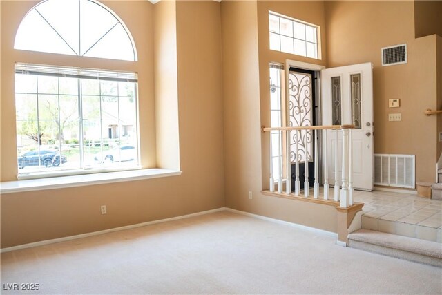 9704 Falling Star Ave, Las Vegas, NV 89117 - foyer featuring carpet, plenty of natural light, baseboards, and a towering ceiling