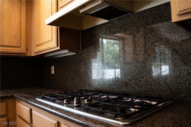 9704 Falling Star Ave, Las Vegas, NV 89117 - kitchen with stainless steel gas cooktop, tasteful backsplash, dark countertops, and under cabinet range hood