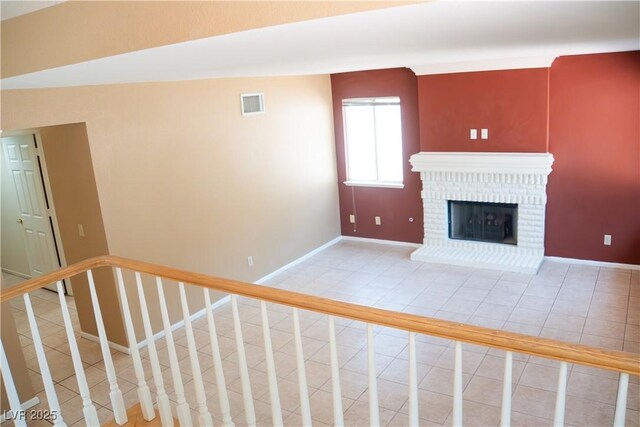 9704 Falling Star Ave, Las Vegas, NV 89117 - unfurnished living room with tile patterned floors, baseboards, a fireplace, and stairs