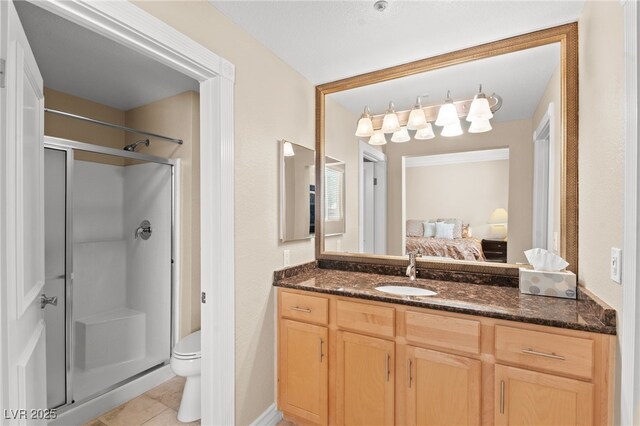 220 E Flamingo Rd Unit 111, Las Vegas, NV 89169 - ensuite bathroom with a shower stall, toilet, vanity, and tile patterned floors