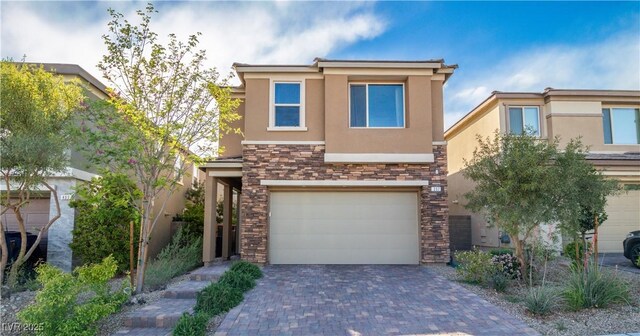 397 Purple Sandpiper St, Las Vegas, NV 89138 - view of front of house with stucco siding, stone siding, a garage, and decorative driveway