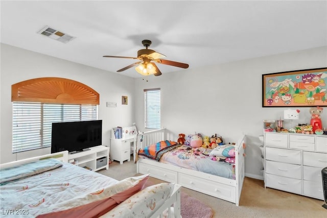 bedroom featuring light carpet and a ceiling fan