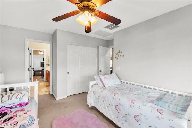 bedroom featuring light carpet, a closet, ceiling fan, baseboards, and connected bathroom
