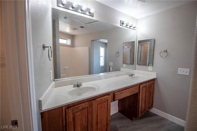 6652 Weeping Pine St, Las Vegas, NV 89149 - full bath featuring double vanity, wood finished floors, and baseboards