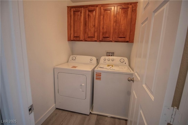 6652 Weeping Pine St, Las Vegas, NV 89149 - laundry area with separate washer and dryer, cabinet space, and wood finished floors
