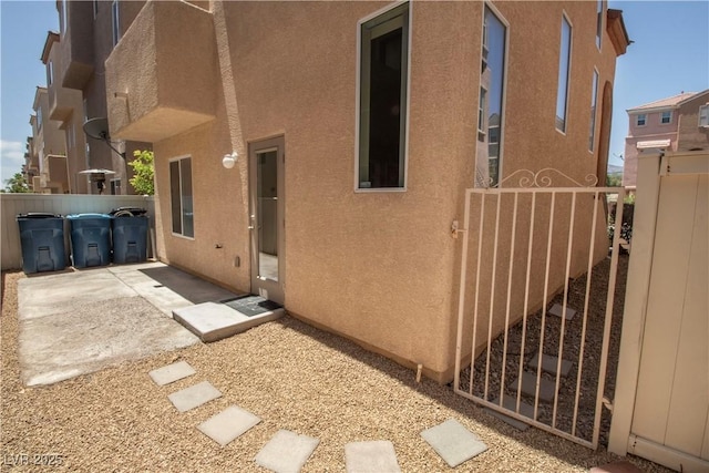 6652 Weeping Pine St, Las Vegas, NV 89149 - rear view of house featuring stucco siding and a gate