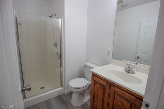 6652 Weeping Pine St, Las Vegas, NV 89149 - bathroom with a stall shower, toilet, vanity, and wood finished floors