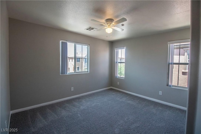 6652 Weeping Pine St, Las Vegas, NV 89149 - empty room featuring ceiling fan, dark carpet, a textured ceiling, and baseboards