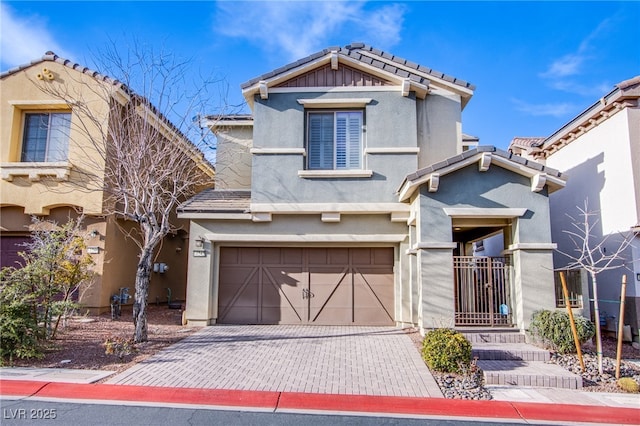 craftsman-style home with an attached garage, a tiled roof, stucco siding, and driveway