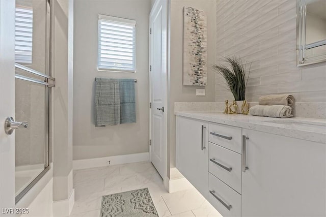 2910 Raywood Ash Dr, Las Vegas, NV 89138 - bathroom featuring baseboards, vanity, an enclosed shower, and marble finish floor