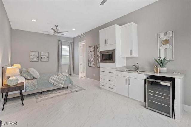 2910 Raywood Ash Dr, Las Vegas, NV 89138 - bedroom with baseboards, wine cooler, marble finish floor, and a sink