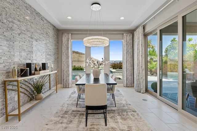 2910 Raywood Ash Dr, Las Vegas, NV 89138 - dining room featuring a tray ceiling and a notable chandelier